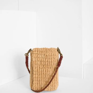 Die von Hand gefertigte Handytasche VAO von IBELIV besteht aus Raphia. Sie hat einen abnehmbaren Riemen aus geflochtenem Leder, mit dem sie über die Schulter getragen werden kann.